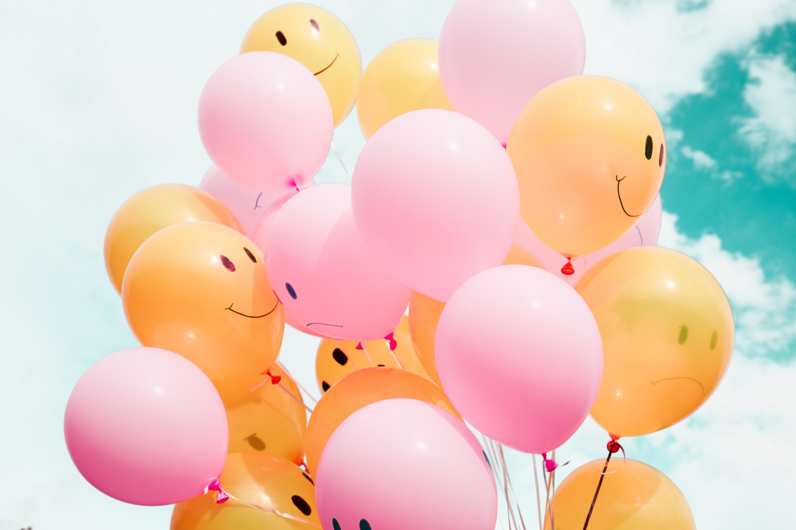 Photo by Madison Oren low-angle photo of pink and orange balloons